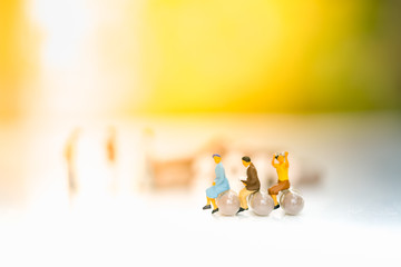 Miniature people: Small businessmen sitting on capsule. Education, Healthcare concept.