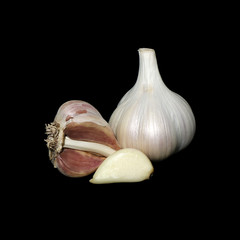 Garlic onion and peeled clove isolated on black background.