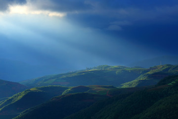 Beautiful light beam in morning with red soil and village on mountain valleys at Hongtudi,Dongchuan, Yunnan,Kunming of China