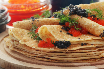 Russian pancakes with red and black caviar