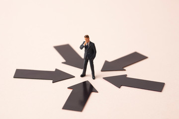 black arrows with miniature business man