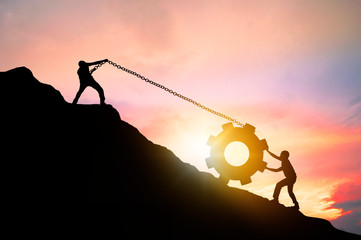 silhouette of business success, teamwork and motivation concept, people help friend to pull machinery circle to hiking  mountain