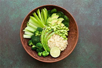 Salad bowl with quinoa and green vegetables. Green vegetables cucumber, pepper, celery, broccoli, avocado, spinach, edamame beans