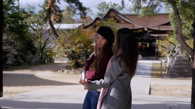 Cute international friends taking photos outside Kyoto temple. 4K