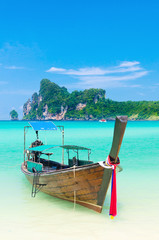 Fototapeta na wymiar Single longtail boat on the Loh Dalum beach, Phi-Phi Don island,