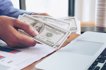 Business Woman Holding Dollar Banknote in Hand at Office