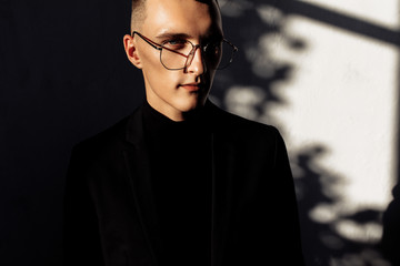 Attractive young man in black suit