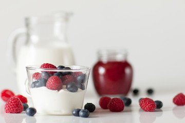 Yogurt with blueberry and raspberry berries in a glass Cup on a white background. Breakfast. Healthy diet.