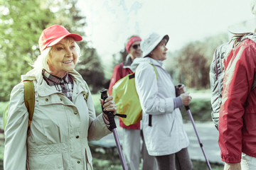 Active elderly woman hiking with her friends