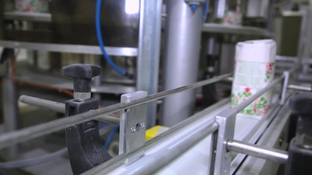 Sugar in packs on the conveyor in the factory