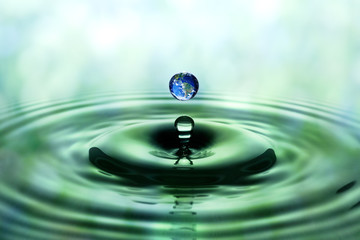 Falling drop of water with blue earth image