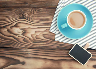 Coffee cup top view on wooden background.