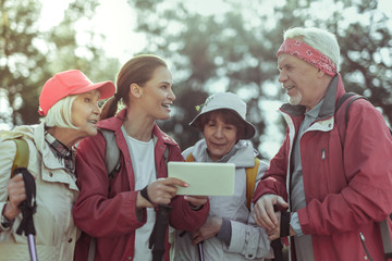 Tourists using a tablet with gps app for hiking