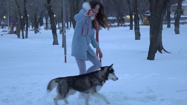 Woman Walk In The Winter Forest With A Dog