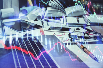 Double exposure of stock market chart and office desktop on background. financial strategy concept.
