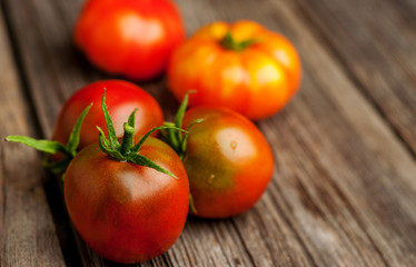 Fresh ripe tomatoes on wooden background. Top view or flat lay