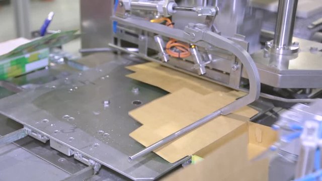 Sugar in packs on the conveyor in the factory