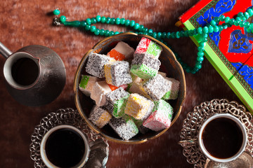 Traditional turkish coffee and turkish delight on wooden background.