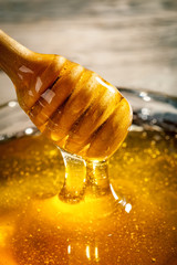 Honey with gold color flows down from a spoon. Healthy food concept. Healthy eating. Diet. Selective focus.