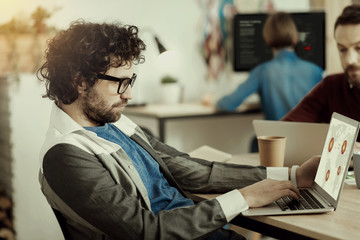 Trade marketing specialist thinking on a graphics.