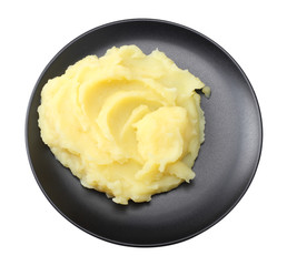 Mashed potatoes on black plate isolated on white background. top view.