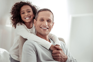 Smiling high-spirited kid and father spending time together