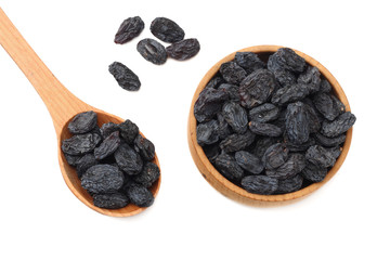 black raisins in wooden bowl isolated on white background. top view