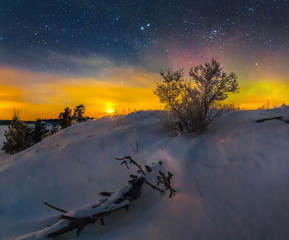 Northern lights on Lake Ladoga in the Republic of Karelia. Full moon and northern lights on the lake. Night panoramas.