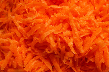 Juicy bright grated carrots. Concept- vegetarianism, raw food, recipe.