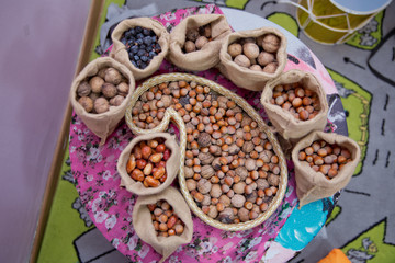 Mix of hazelnut and walnuts with hard shell . dried hazelnuts and walnuts, closeup . Hazelnuts, walnuts, nuts, and small bags in a bowl. Hazelnuts, walnuts, Buta is in khonca .