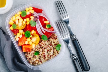 Healthy vegan meal prep containers with quinoa and fresh vegetables