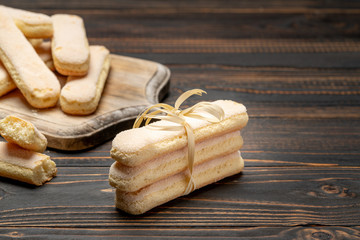 Fototapeta premium Italian Savoiardi ladyfingers Biscuits on wooden backgound with copy space