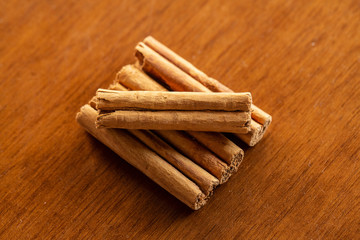 Pieces of cinnamon on wooden background