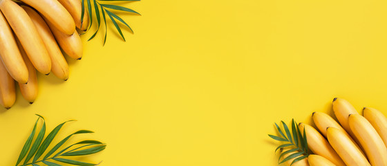 Bright yellow background with bunch of bananas - 250192901