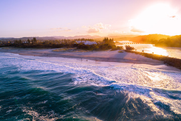 Aerial view of Palm Beach suburb coastline at sunset. People on the beach. Gold Coast, Queensland, Australia