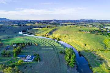 Aerial panorama of river flowing in beautiful Australian countryside at sunset. Yass, New South...