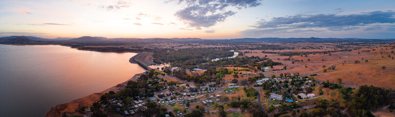 Wide aerial panorama of Lake Hume Village and Murray River surrounded by scenic countryside and hills at dusk
