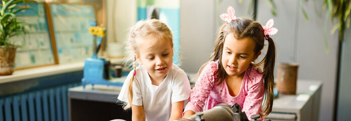 Parent and pupil of primary school go hand in hand. Woman and girl with backpack . Beginning of lessons. First day of fall.