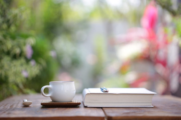 White cup with diary notebook at outdoor