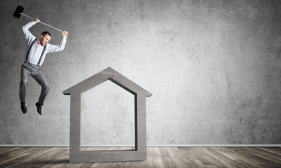 Stone home silhouette in empty room as symbol for real estae insurance