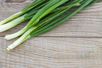 Fresh green onion on rustic wooden table