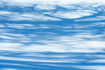 Snowdrift background with shadow of trees