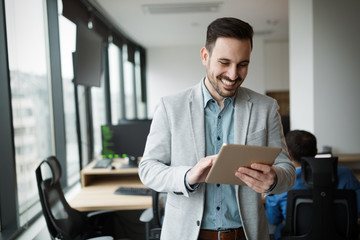 Young businessman using digital tablet in office