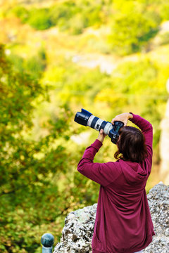 Photographer woman taking pictures of nature