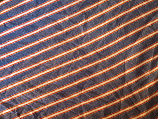 Orange and yellow plaid print as background. Symmetric rhombus pattern.