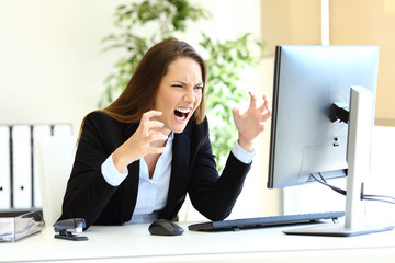 Angry office worker checking computer content