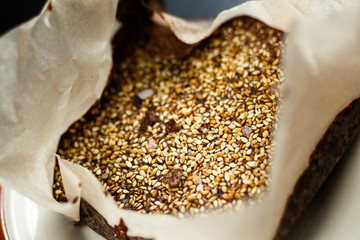Closeup luxury handmade dark chocolate with seasame and sea salt, in paper