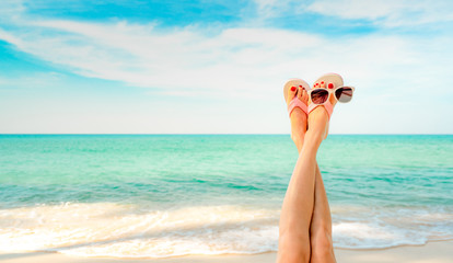 Upside woman feet and red pedicure wear pink sandals, sunglasses at seaside. Funny and happy fashion young woman relax on vacation. Girl on beach. Creative for tour agent. Weekend travel. Summer vibes - obrazy, fototapety, plakaty