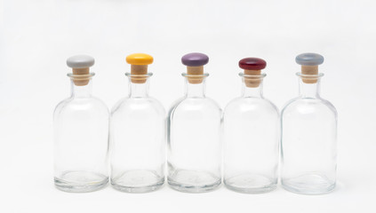 small glass bottles with colored cap