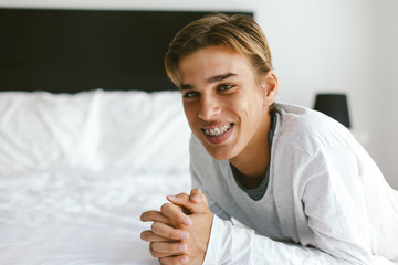 Closeup portrait of a 16 years old teenage guy wearing dental braces